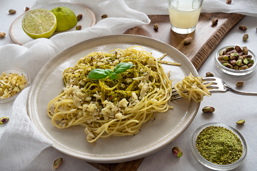 Close-up of a plate of fresh pasta with pistachio
