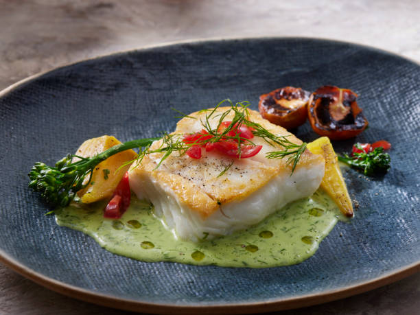 Pan Seared Halibut with a Dill and Buttermilk Sauce Pan Seared Halibut with a Dill and Buttermilk Sauce, Roasted Golden Beets, Cherry Tomatoes, Radish's and Broccolini haddock stock pictures, royalty-free photos & images