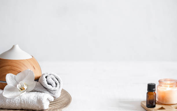 istock Spa composition with aroma diffuser, towel and aroma oil copy space. 1310933519