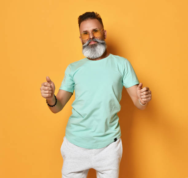 istock Funky man with thumbs up - isolated over a yellow background 1310934410