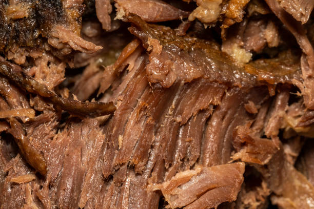 Slow cooked shredded pulled beef close up background