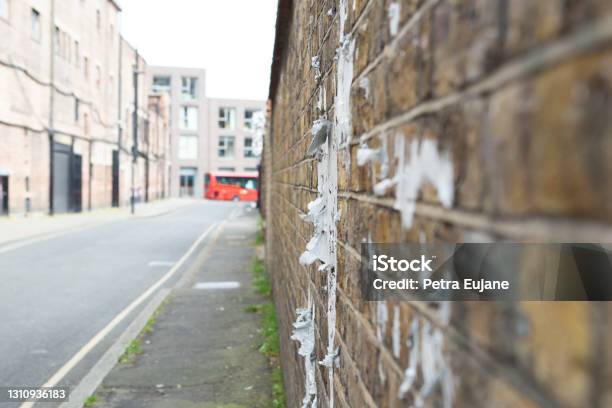 Tattered Poster On A Brick Wall Stock Photo - Download Image Now - Brixton, City, City Life