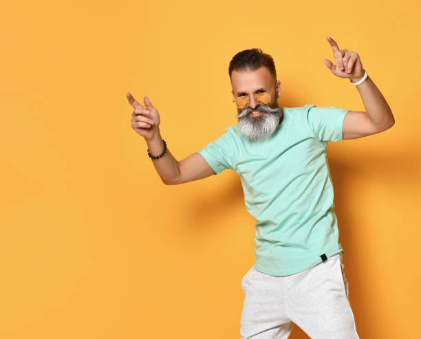 istock Positive smiling bearded man dancing studio shot 1310937351