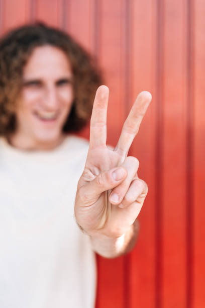 istock Hand gesturing on a symbol of victory with two fingers 1310937404