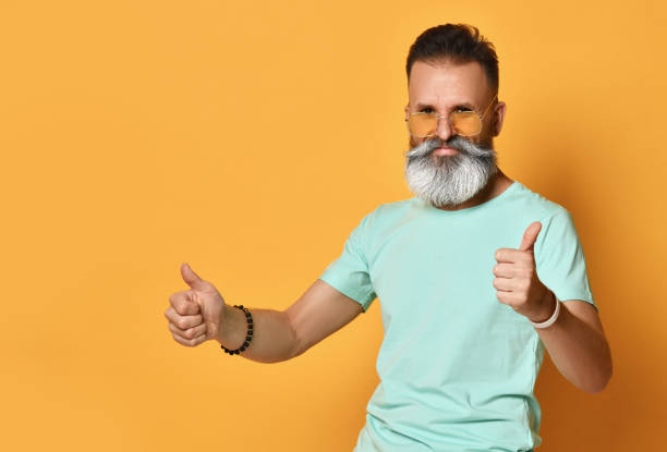 istock Positive smiling bearded man gesturing thumbs-up portrait 1310939556