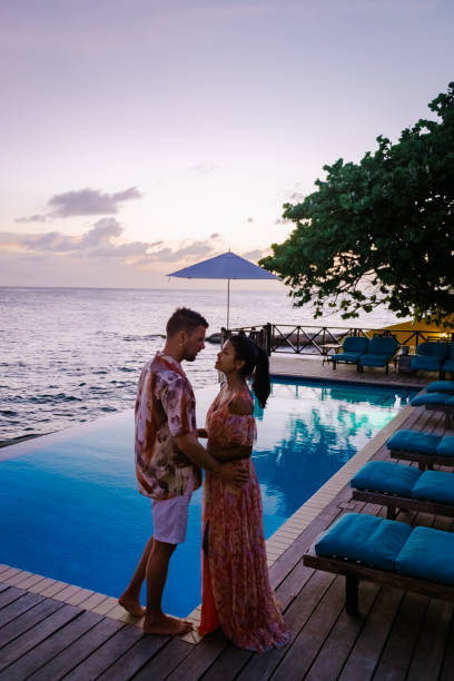 istock Curacao, couple on vacation in Curacao watching sunset by the pool 1310940627