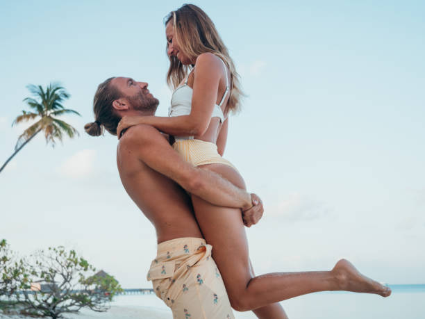 istock Young lifting up girlfriend on tropical beach 1310940805