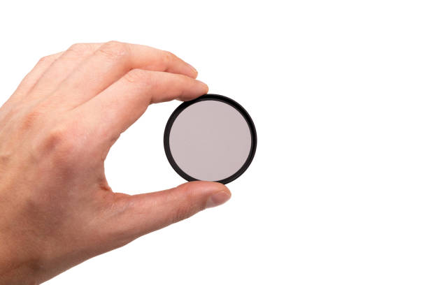 istock polarizing filter for the camera in hand. isolated on a white background 1310940885