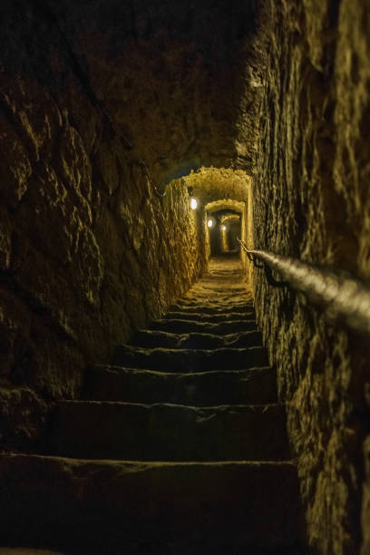 istock long stone corridor with lamps and stairway with rail 1310941198
