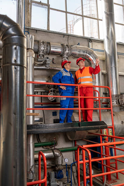 istock Maintenance Engineer Standing Next to Oil Worker in Oil Refinery 1310942461