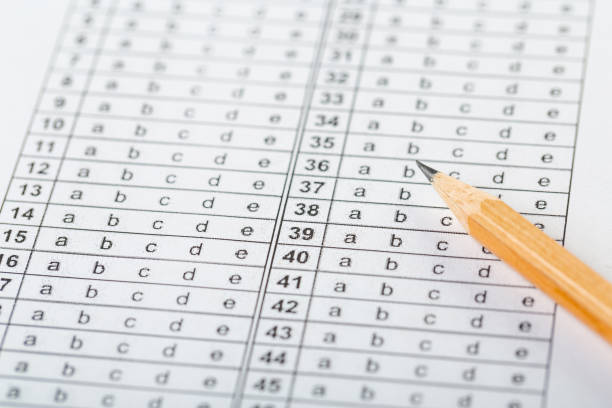 istock testing in exercise and exam paper. computer sheet with pencil in school test room, education concept 1310943702