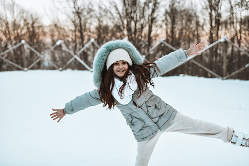 Small Female Child Enjoying Playing In Snow