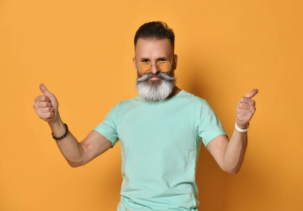 istock Funky man with thumbs up - isolated over a yellow background 1310943909