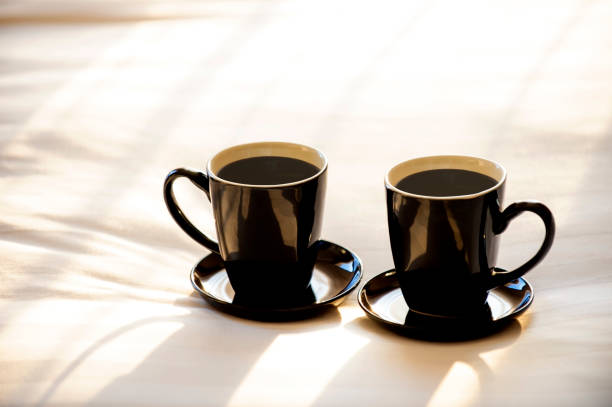 istock Two coffee mugs are placed on the bed. 1310944289