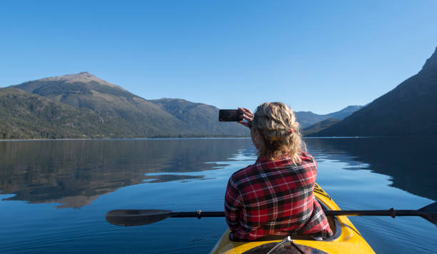 beautiful woman taking a selfie from her kayak. - bariloche patagonia argentina lake imagens e fotografias de stock