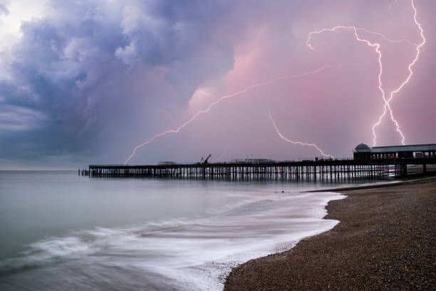 Stunning Lightning storm landscape over pier under construction and development in remote location stock photo