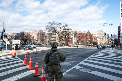 A member of the National Guard stands at an intersection in Washington DC, part of a large security contingent in January 2021.