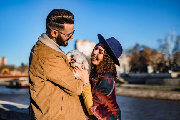 istock Couple with dog enjoying on riverbank 1310948940