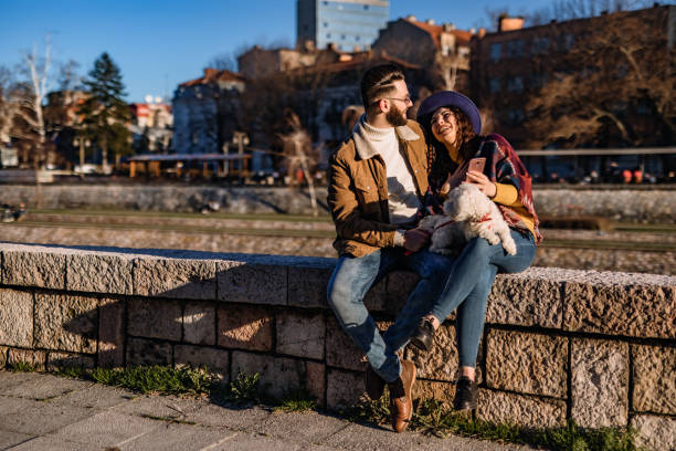 istock Couple with dog enjoying on riverbank 1310948967