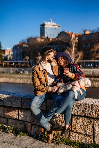 istock Couple with dog enjoying on riverbank 1310949098