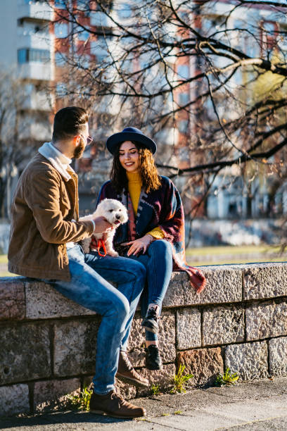 istock Couple with dog enjoying on riverbank 1310949493
