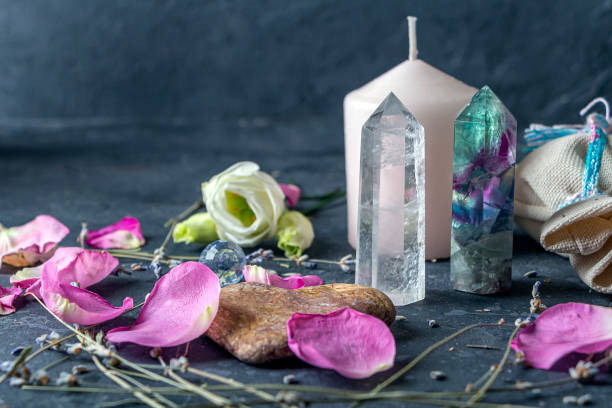 Magic composition with pink candle, crystals, pagan bag and flowers. Esoteric and pagan rituals, witchcraft Wiccan or spiritual practice (healing). Ritual for love. Herbal treatment. Magic composition with pink candle, crystals, pagan bag and flowers. Esoteric and pagan rituals, witchcraft Wiccan or spiritual practice (healing). Ritual for love. Herbal treatment crystal altar stock pictures, royalty-free photos & images