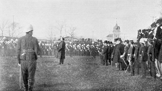 Prime Minister Sir Wilfrid Laurier speaking to the troops before leaving Quebec City, Canada for the Second Boer War in South Africa. Vintage etching circa 19th century.
