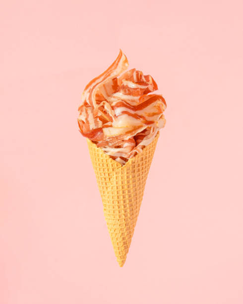 ice cream cone full of crispy bacon against pastel pink background. - bacon ilustrações imagens e fotografias de stock