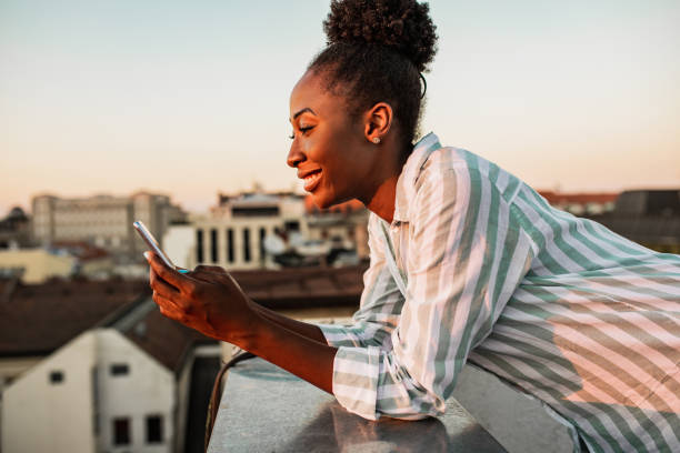 istock African American woman is using mobile phone and relaxing 1310953259