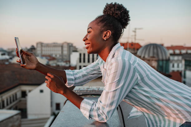 istock African American woman is using mobile phone and relaxing 1310953327