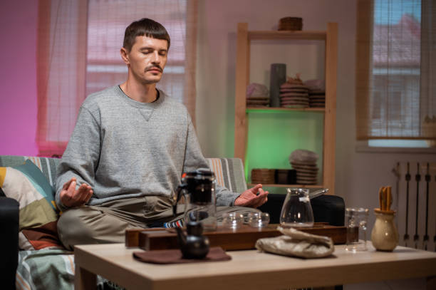 A master of traditional chinese tea drinking meditates at home while waiting for tea to be brewed