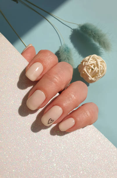 istock female hand beautiful beige manicure on a colored background 1310954599