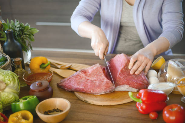istock woman cooking in the kitchen ( beef ) 1310954665