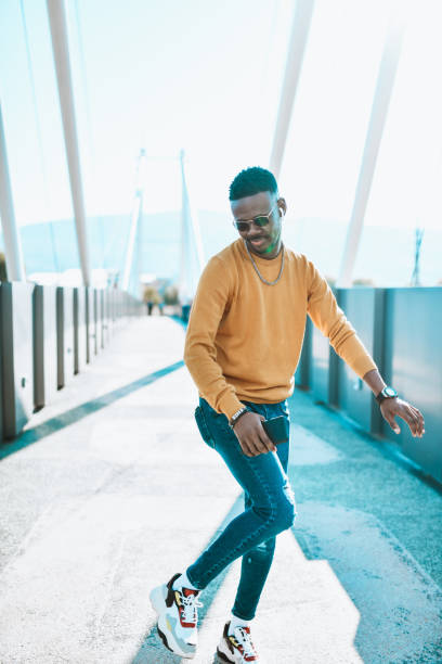 istock Smiling African Male Dancing While Taking A Walk On Bridge Outside 1310954695