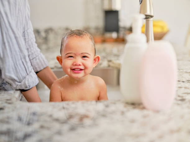 istock Baby Bathing in a Kitchen Sink 1310956181