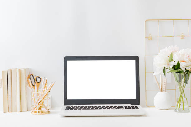 istock Office workspace with laptop mockup screen, books, mood board, supplies on a light background. Home interior or office background 1310956628