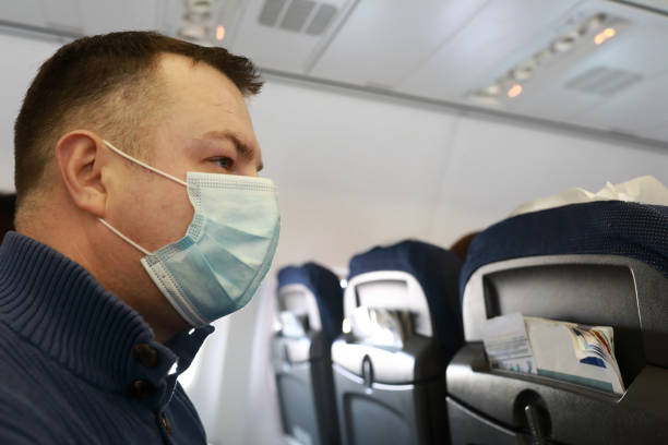 istock Man in medical mask on board aircraft 1310957027