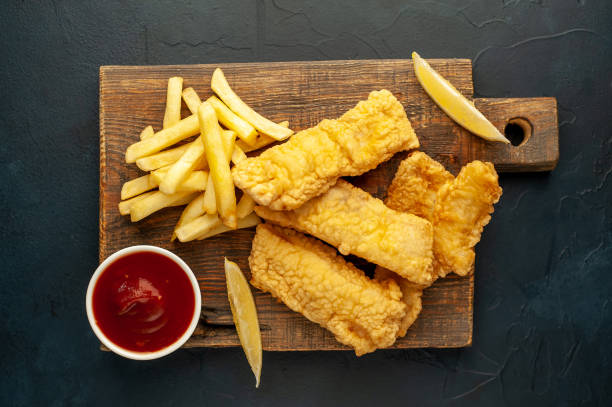 istock fish and chips with French fries, on a stone background 1310957810