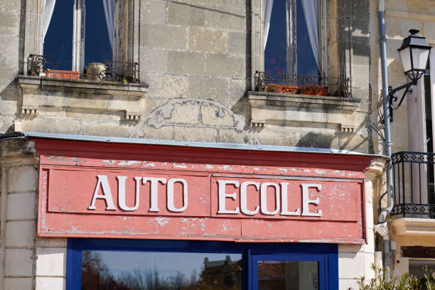 text auto ecole french means driving school in old signage in france vintage ancient building facade text auto ecole french means driving school in old signage in france vintage ancient building facade ecole stock pictures, royalty-free photos & images