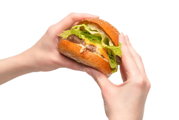 istock Hamburger in woman hands isolated on a white background. 1310958546
