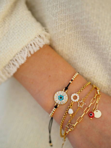 istock Bracelets Accumulation on a woman hand on a white jacket 1310958548