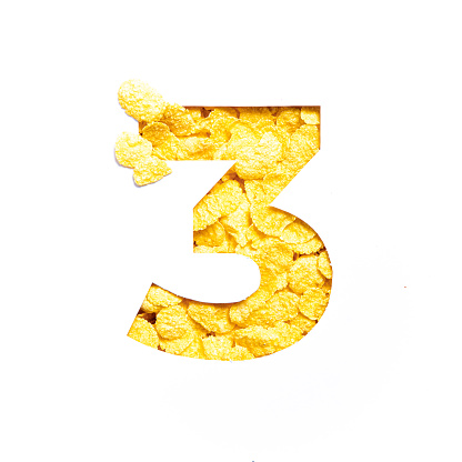 Number three made of corn flakes, paper cut in shape of third numeral isolated on white. Typeface for healthy food store. High quality photo
