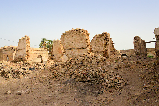 Massawa, Northern Red Sea Region, Eritrea: war damage - rubble and ruins on Via Palermo, remains of a large Ottoman period building with a coral stone structure, flattened by bombs - during the Independence war, the old town was attacked by Soviet naval artillery in 1977 and suffered further in 1990 during the Second Battle of Massawa (also known as the Fenkil offensive) - Massawa old town / Batse island.