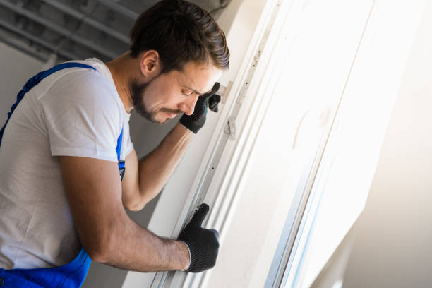 istock The worker installs a window frame in the room 1310961869