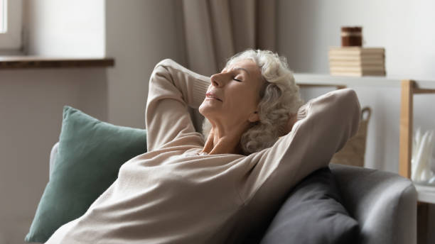 istock Peaceful older 60s lady resting on comfortable couch 1310961941