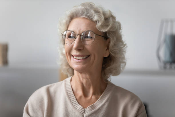 istock Happy pensive elderly lady wearing glasses, looking at window 1310961974