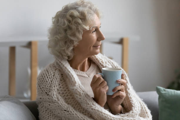 istock Happy pensive elderly lady wrapped in scarf 1310961985