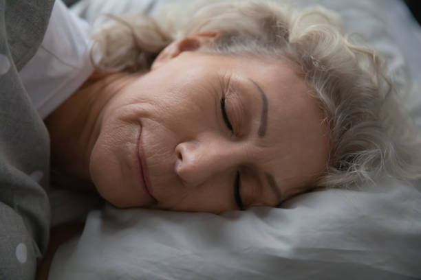 istock Calm serene old 60s lady enjoying good healthy sleep 1310962047