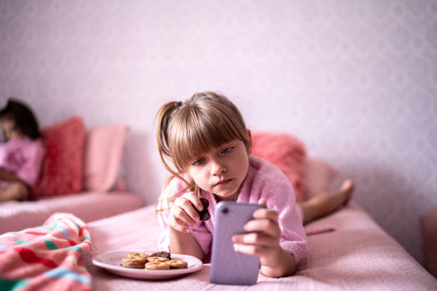 istock Girl in bed using smartphone wearing bathrobe at home 1310962503