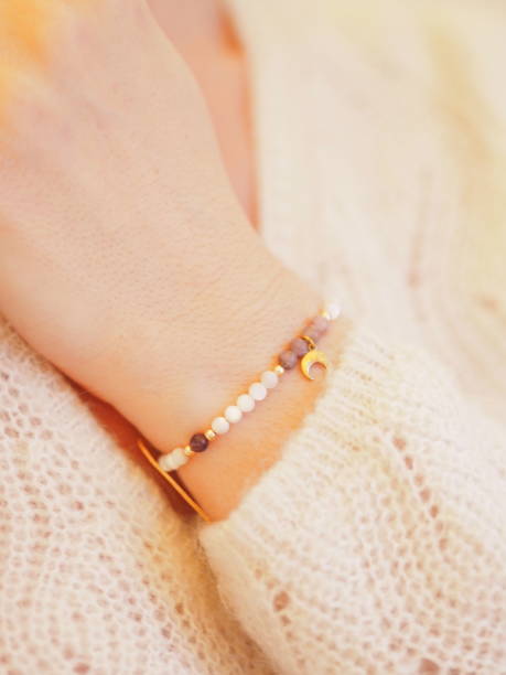 istock Bead bracelet on a woman hand on a wool sweater 1310963336